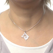 Close up of model wearing a sterling silver Alaskan Klee Kai pendant on an 8 sided snake chain.