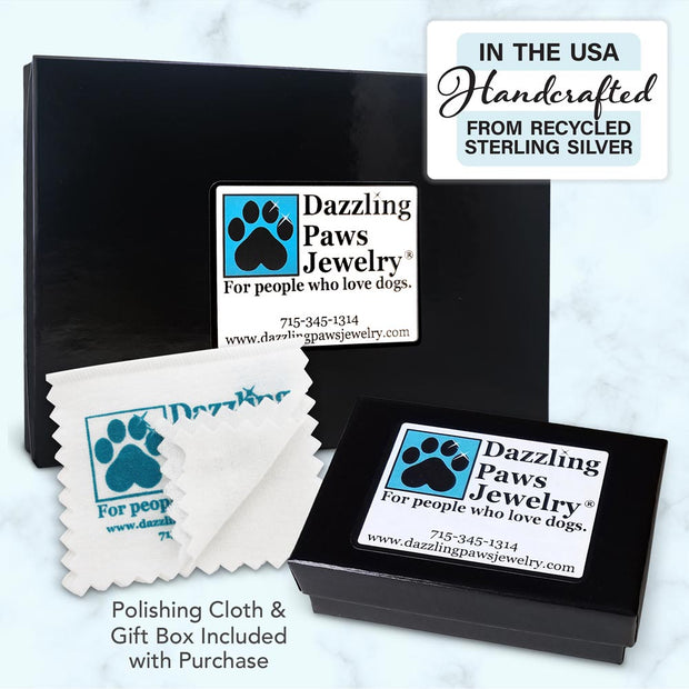 Display of multiple glossy black gift boxes with the Dazzling Paws Jewelry logo and a polishing cloth.