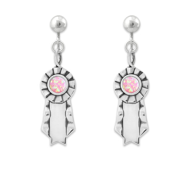 Silver clip on ribbon earrings with pink opal cabochon centers on a white background