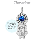 Silver ribbon pendant with blue cabochon and 'GCH' engraving on a white background, featuring the font 'Clarendon'.